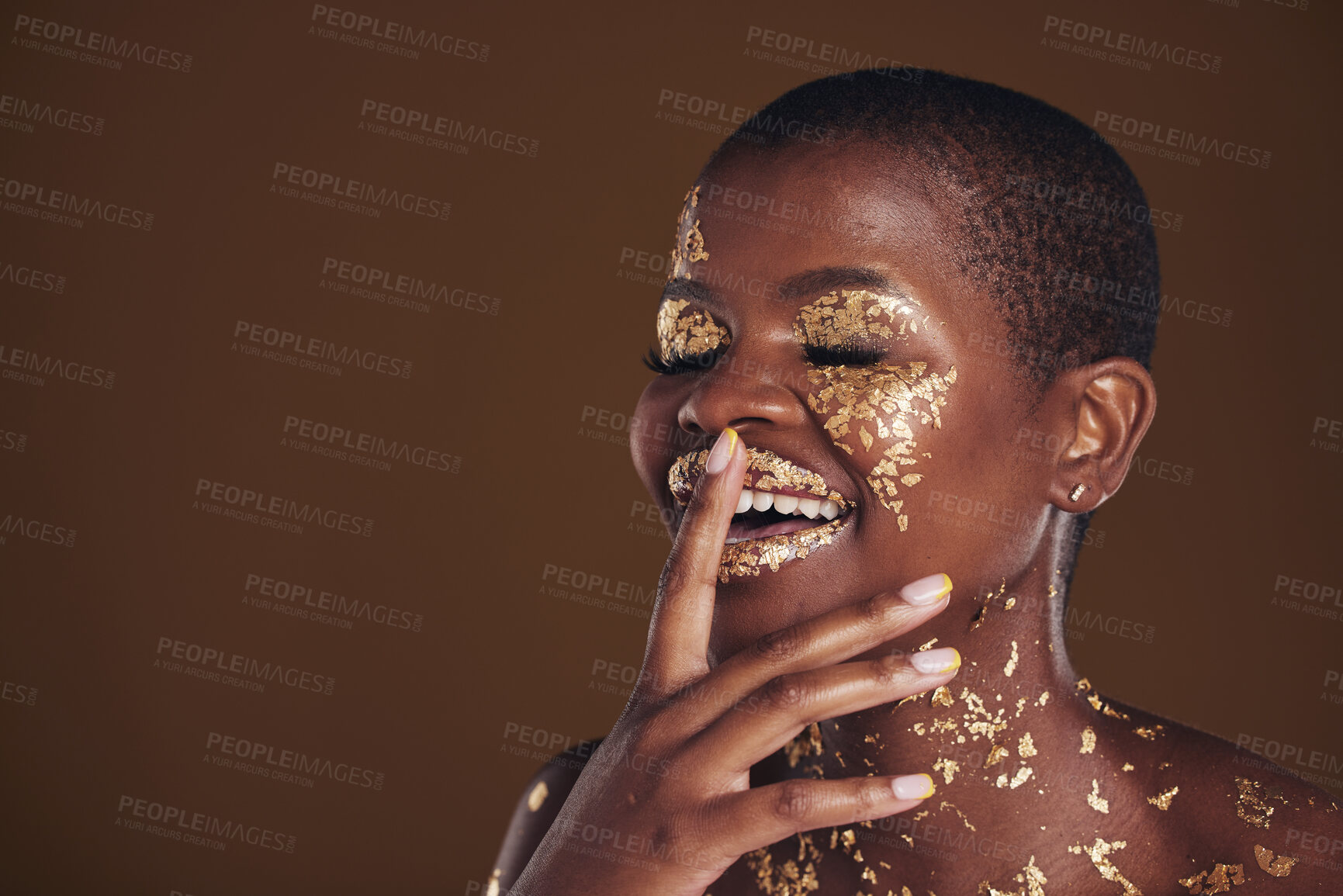 Buy stock photo Happy laugh of black woman with gold makeup, mockup on brown background and glitter paint for cosmetics. Shine, glow and smile, African model in studio for facial beauty and funny aesthetic luxury.