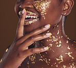 Gold, smile and woman mouth closeup with makeup and luxury treatment with rich spa mask. Glitter, golden dermatology and African person happy from creative skincare and art cosmetics in studio