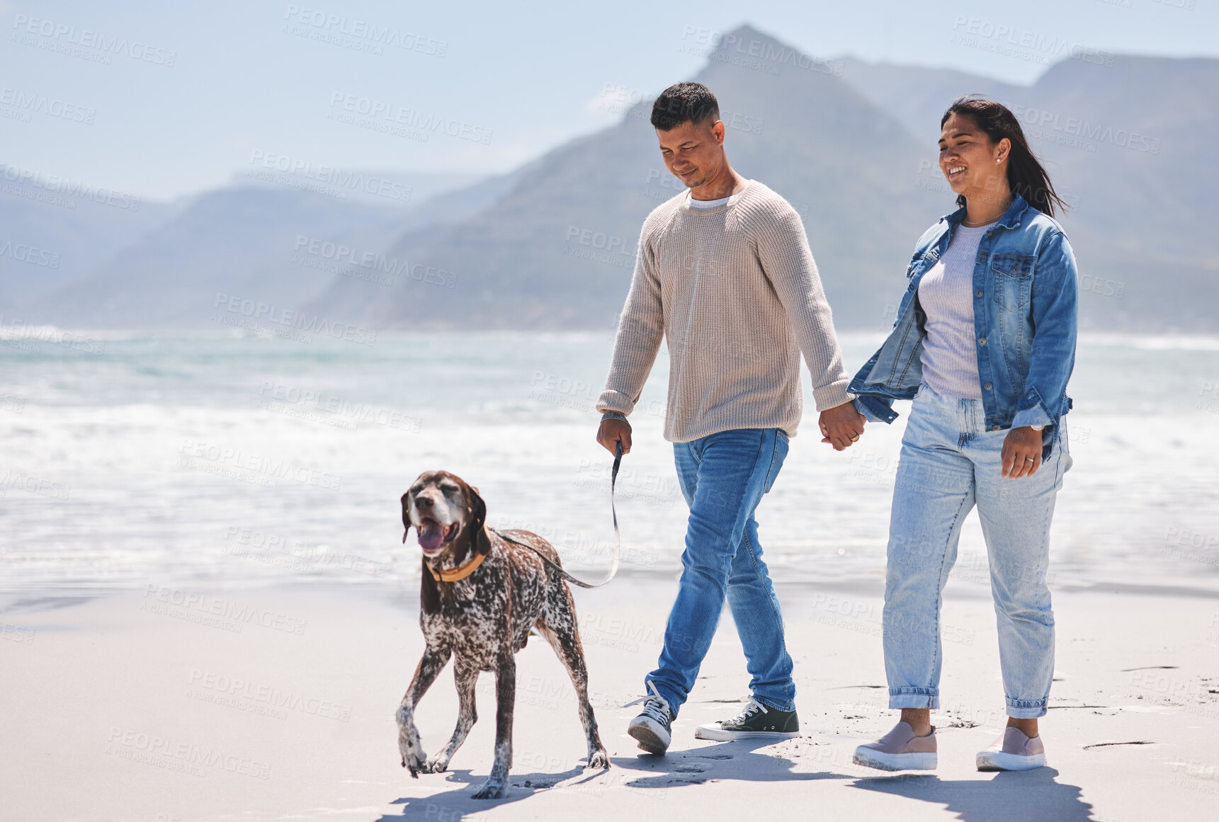 Buy stock photo Beach, walking and couple with dog by ocean for freedom, adventure and bonding together in nature. Happy pet, excited canine and man and woman holding hands by sea for exercise, wellness and health