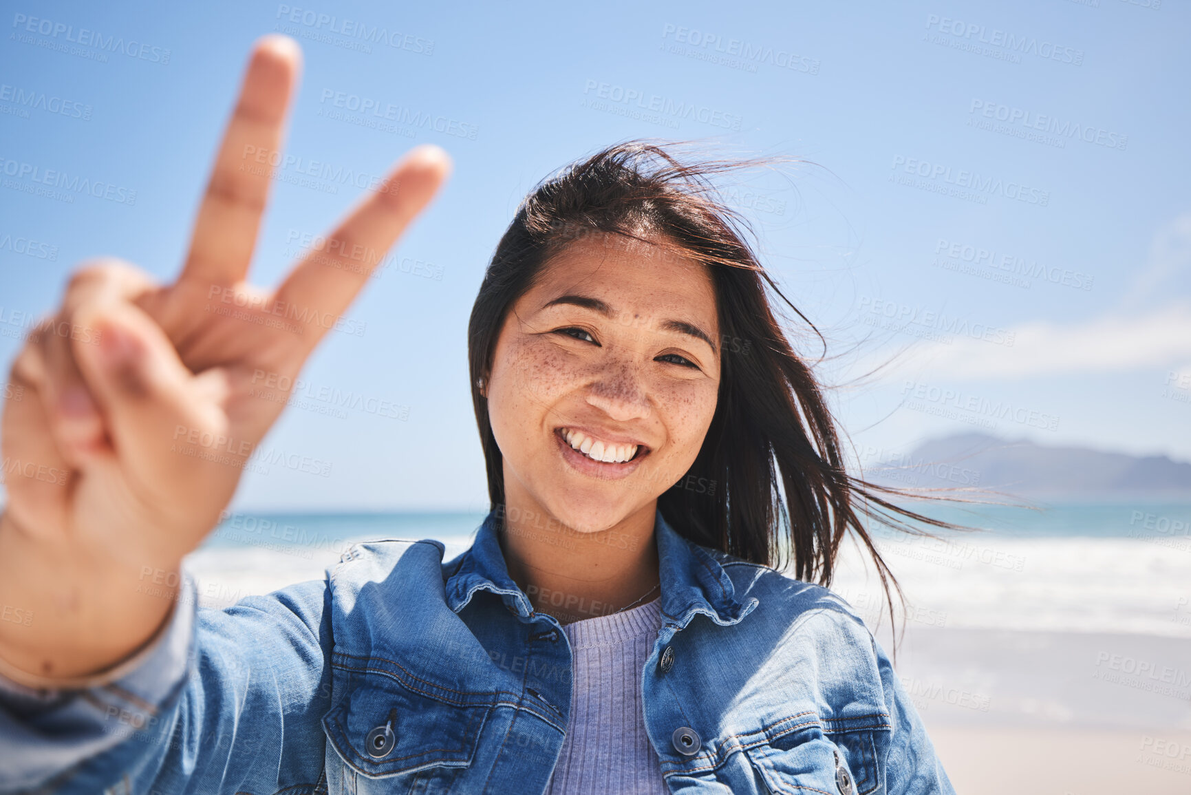 Buy stock photo Portrait, woman and sign for peace on beach, holiday or profile picture from vacation in Indonesia on summer or break. Happy, face and smile at the ocean, sea or person travel in nature with freedom