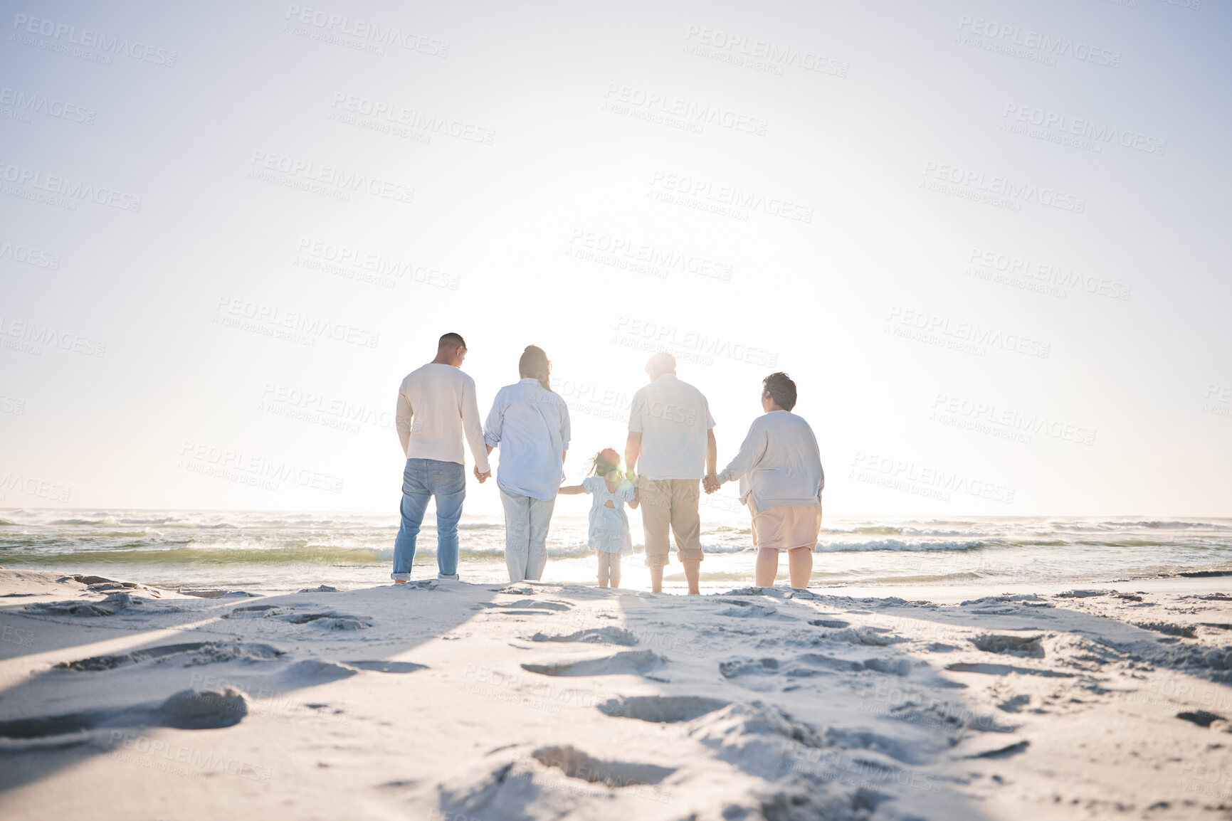 Buy stock photo Summer, travel and holding hands with big family on beach for vacation, bonding and love. Freedom, care and relax with group of people walking at seaside holiday for generations, happiness and mockup