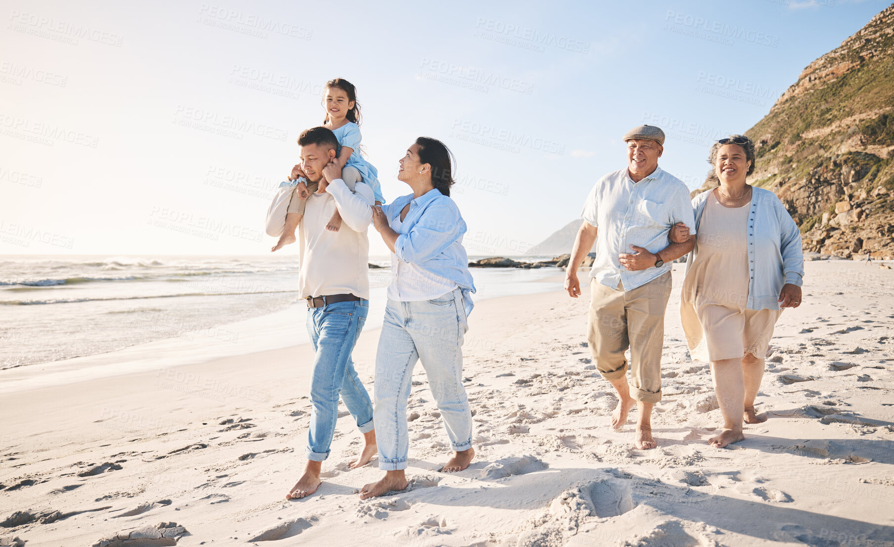 Buy stock photo Summer, travel and love with big family on beach for vacation, bonding and fun. Freedom, care and relax with group of people walking at seaside holiday for generations, happiness and support together