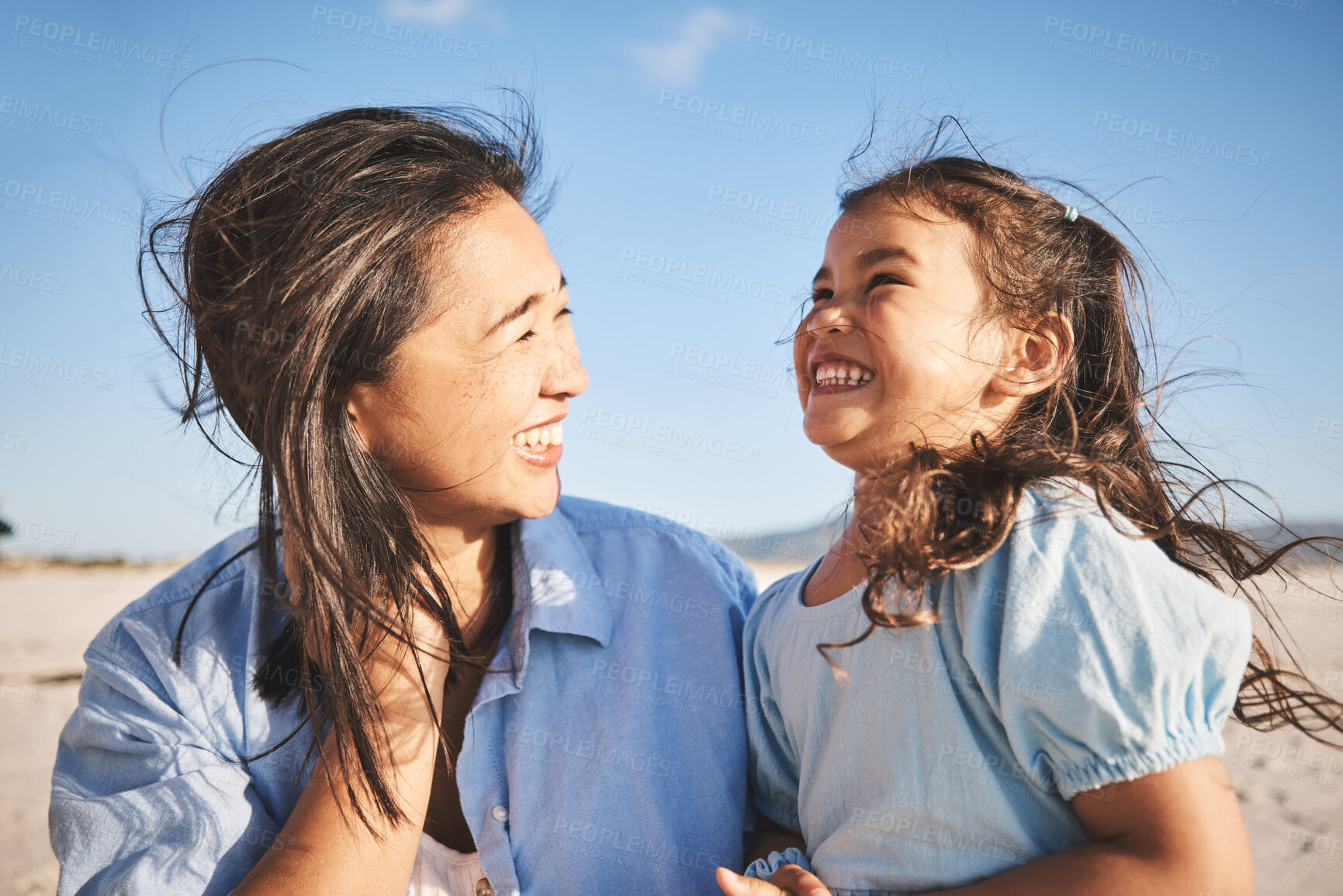 Buy stock photo Laughing, care and a mother and child at the beach for family, travel or summer freedom. Happy, young and a mom with a girl kid at the ocean for a holiday, bonding or together with love at the sea