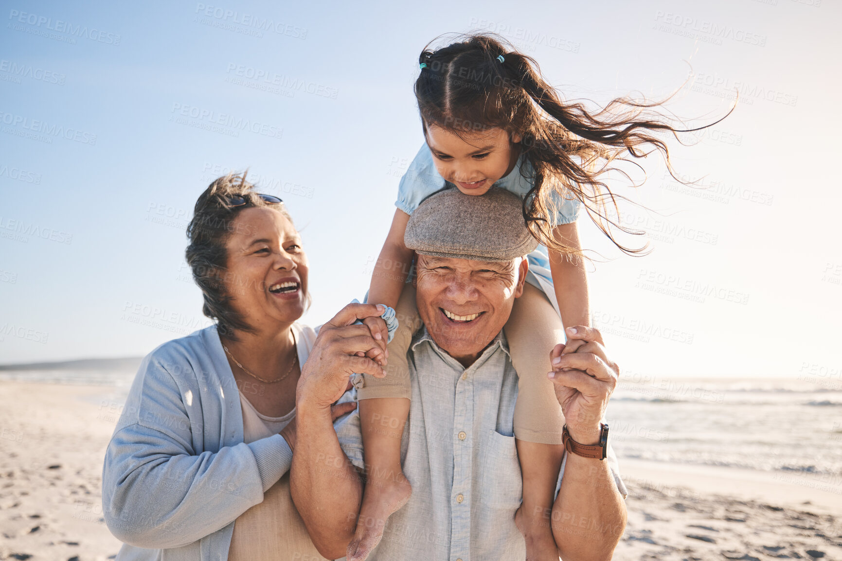 Buy stock photo Happy, beach and girl bonding with her grandparents on a tropical family vacation or adventure. Smile, sunset and child playing with her grandmother and grandfather by the ocean on holiday together.