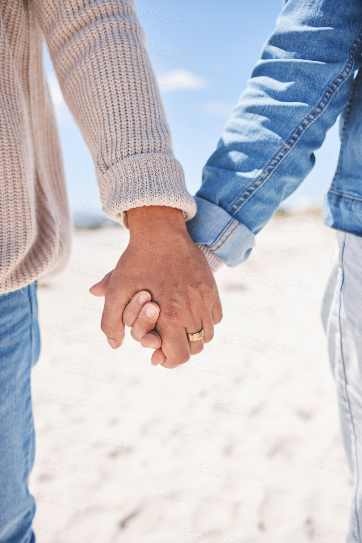 Buy stock photo Beach, closeup and couple holding hands for love, commitment and marriage in nature. Travel, bonding and man and woman together by ocean for care, trust and affection on holiday, vacation and weekend