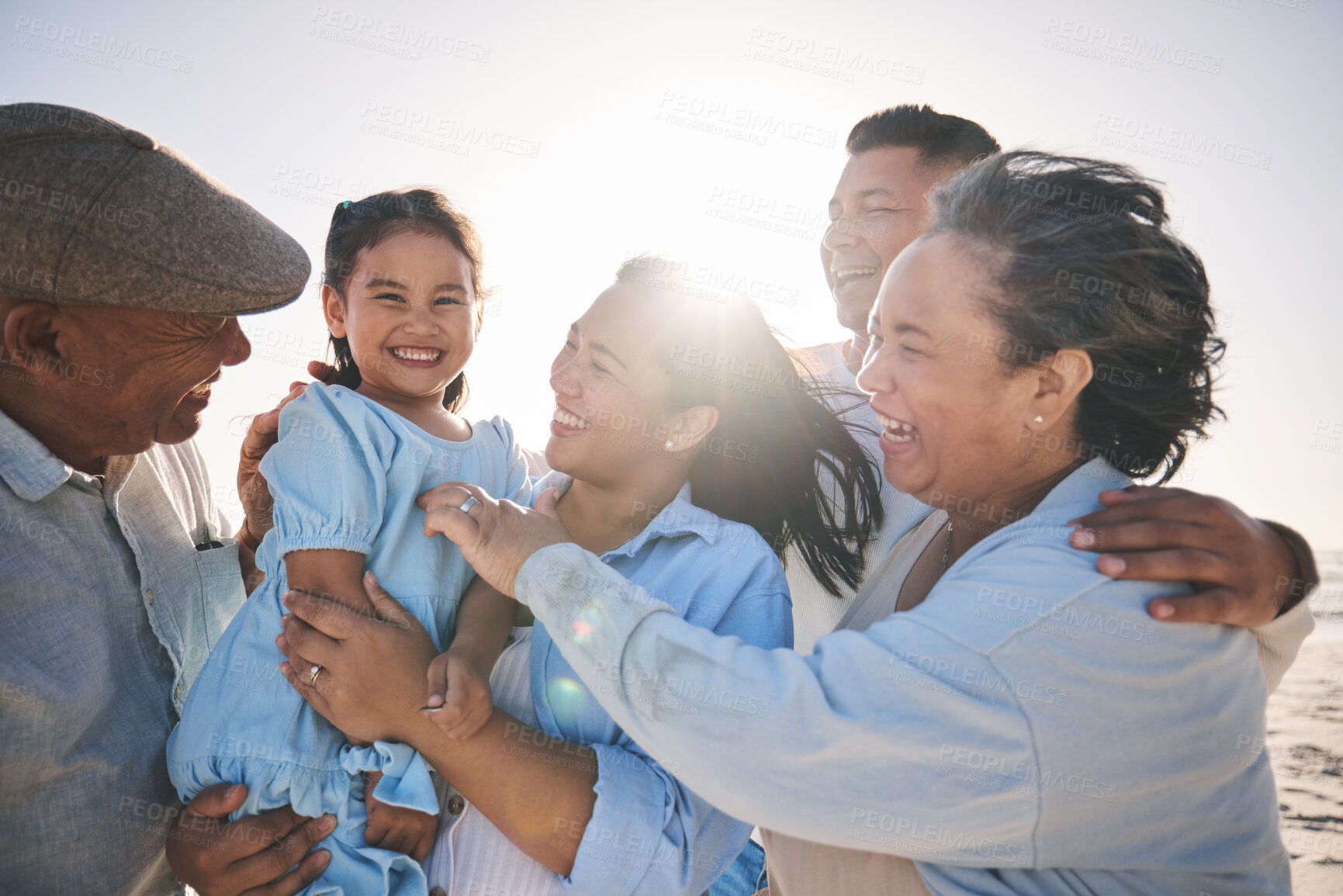 Buy stock photo Family, smile and a girl on the beach with her grandparents in summer for holiday or vacation together. Love, sunset or flare with parents, kids and senior people by the ocean or sea for bonding