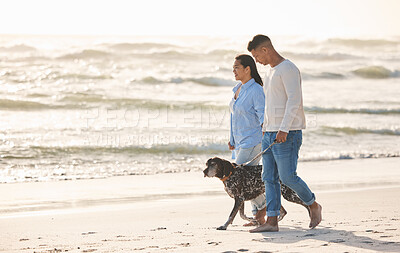 Buy stock photo Beach, pet and couple walking with dog by ocean for freedom, adventure and bonding together in nature. Healthy animal, dating and man and woman by sea for exercise, wellness and training at sunset