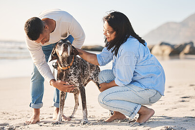 Buy stock photo Beach, love and couple with dog by ocean for freedom, adventure and bonding together in nature. Happy pet, petting canine and man and woman by sea for exercise, wellness and training outdoors