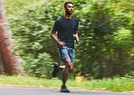 Man running with speed in park for exercise, fitness and power of cardio workout, action and race. Runner, sports athlete and motion blur for marathon training, energy and fast performance outdoor 