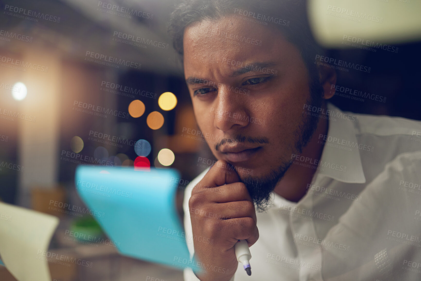 Buy stock photo Businessman, thinking and reading a note in office at night for planning a marketing strategy for professional startup in Egypt. Man, working and idea for corporate company, workplace or overtime