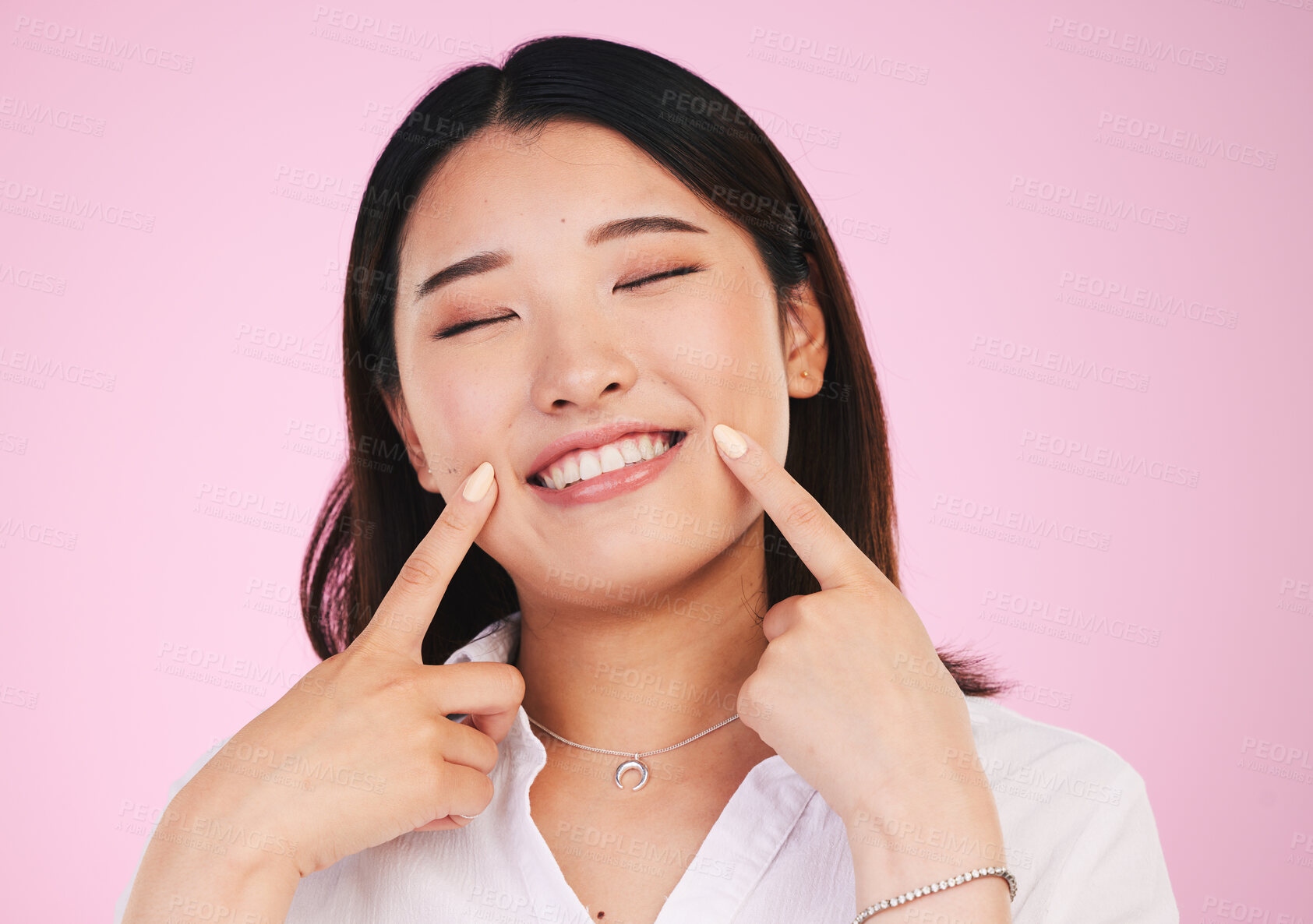 Buy stock photo Asian woman, face and hands on smile for teeth, whitening and dental wellness or beauty on pink background in studio. Tooth, care and portrait of model with happiness for cosmetics and dentistry