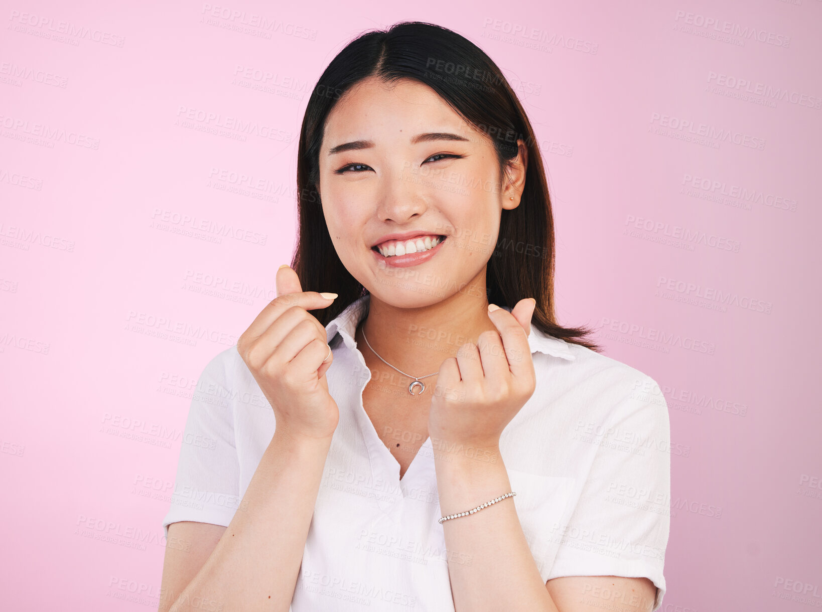 Buy stock photo Happy asian woman, portrait and love hands, sign or gesture in romance against a pink studio background. Face of female person smile in happiness with loving emoji or symbol for valentines day