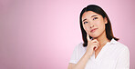 Asian woman, thinking and decision on mockup in problem solving against a pink studio background. Female person with idea, solution or choice in memory, reminder or  brainstorming on mock up space