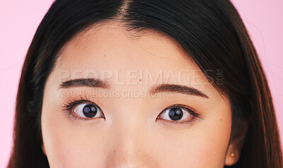 Closeup, eyes and portrait of an Asian woman on a pink background for makeup or microblading. Face, skincare and a girl or model isolated on a backdrop for facial cosmetics, foundation or eyeliner