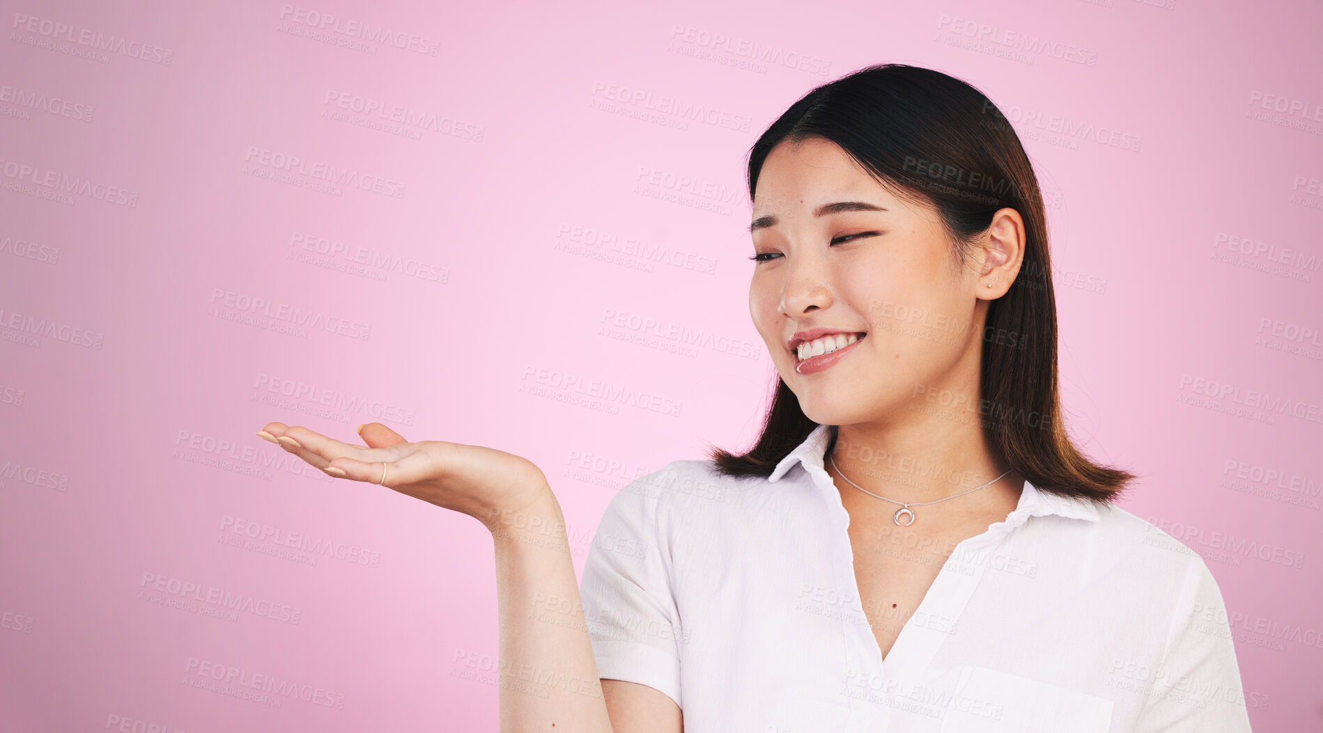 Buy stock photo Happy asian woman, palm and advertising on mockup space in marketing against a pink studio background. Female person with hands out in market show, presentation or product advertisement on mock up