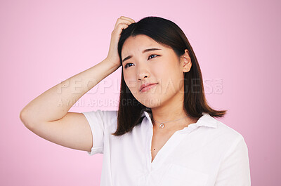 Buy stock photo Thinking, confused and question with an asian woman on a pink background in studio for problem solving. Face, doubt or why and a young person scratching her head with a mistake, error or fail