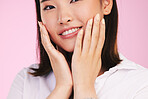 Woman, hands on face and manicure, beauty and makeup with cosmetics isolated on pink background. Asian model, nail polish and self care, portrait and dermatology with skin glow and wellness in studio