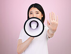 Megaphone announcement, portrait and Asian woman with stop hand sign for justice,  human rights rally and end racism. Warning speech, studio and Japanese female speaker revolution on pink background