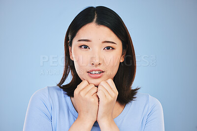 Buy stock photo Asian, portrait and scared woman with surprise from announcement, news or horror story on blue background in studio. Shock, face and person in danger with fear in facial expression, hands or reaction