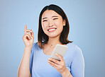 Woman, phone and idea, decision and portrait for university, college or education on blue background. Young asian person or student with solution or thinking on mobile for learning or chat in studio