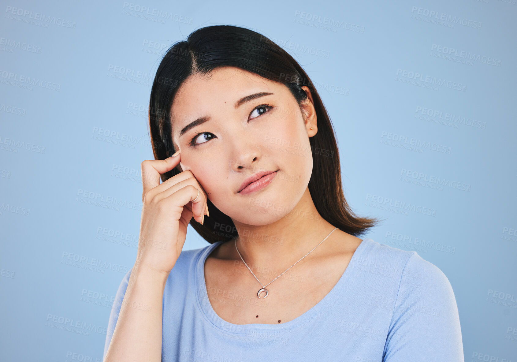Buy stock photo Decision, thinking and Asian woman with ideas, choice and problem solving on a blue studio background. Solution, Japanese person or model brainstorming, doubt and mockup space with questions or emoji