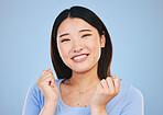 Happy, Asian and portrait of a woman on a blue background for cosmetics face headshot. Smile, beauty and a girl or model with dental care, beautiful and makeup for cheerful personality in studio