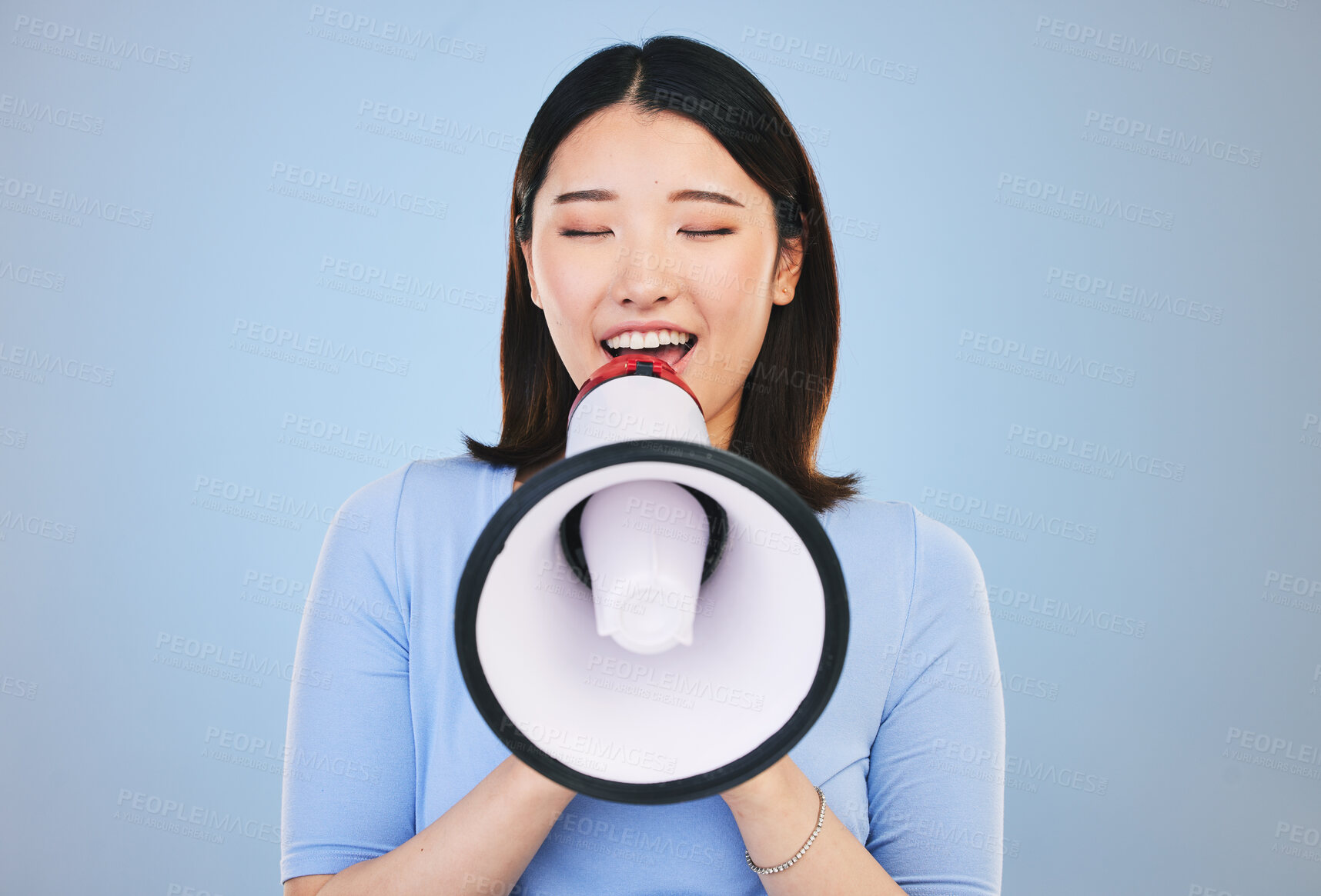Buy stock photo Woman, megaphone and voice for news, broadcast or student sale and announcement on blue background. Young asian person with noise for call to action, university attention or college speaker in studio