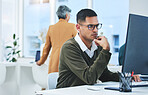 Business man, thinking and focus on computer for information technology, software development and solution. Professional worker reading with glasses for IT decision, programming or planning in office