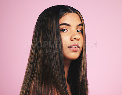 Buy stock photo Portrait, salon and hair with a woman on a pink background in studio for shampoo treatment. Face, skincare or haircare and a confident young model with natural beauty or aesthetic keratin cosmetics