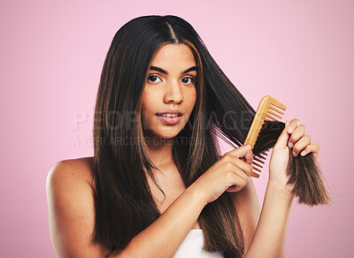 Buy stock photo Portrait, woman and brush hair in studio for smooth texture, shine and keratin treatment on pink background. Natural beauty, face and model with comb tools for aesthetic hairstyle with growth shampoo