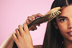 Hair care, brush portrait and woman with natural beauty and salon treatment in a studio. Bamboo hairdresser tool and Brazilian hairstyle with female model face from Brazil with pink background