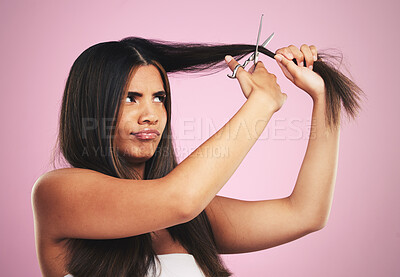 Buy stock photo Hair cut, scissors and frustrated woman with beauty tool and DIY treatment in a studio. Growth issue, annoyed and Brazilian hairstyle with female model from Brazil with equipment and pink background