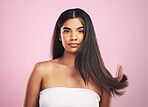 Hair care, portrait and woman with natural beauty and salon treatment in a studio. Shampoo, cosmetics and Brazilian hairstyle with a female model from Brazil with confidence with pink background