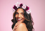 Happy woman, flowers and thinking with crown in studio for natural beauty, skincare and plants on pink background. Face, model and floral wreath for sustainability, eco dermatology and hair cosmetics