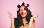Beauty, flower crown and bubbles with woman in studio for cosmetics, skincare and wellness. Hair care, spa treatment and soap with face of person on pink background for spring, glow and makeup