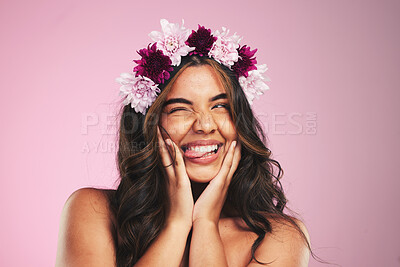 Buy stock photo Beauty, flowers and wink with hairstyle of woman in studio for cosmetics, skincare and wellness. Self care, spa treatment and crown with face of person on pink background for spring, glow and makeup 