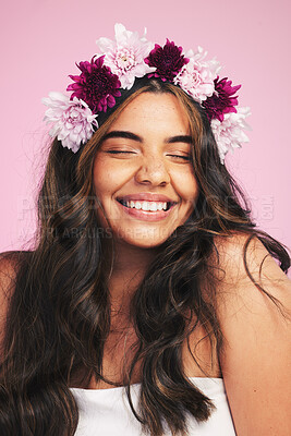 Buy stock photo Woman, flowers and smile with crown on pink background for natural beauty, skincare and self care in studio. Face, happy model and floral hair band for sustainability, eco dermatology and cosmetics 