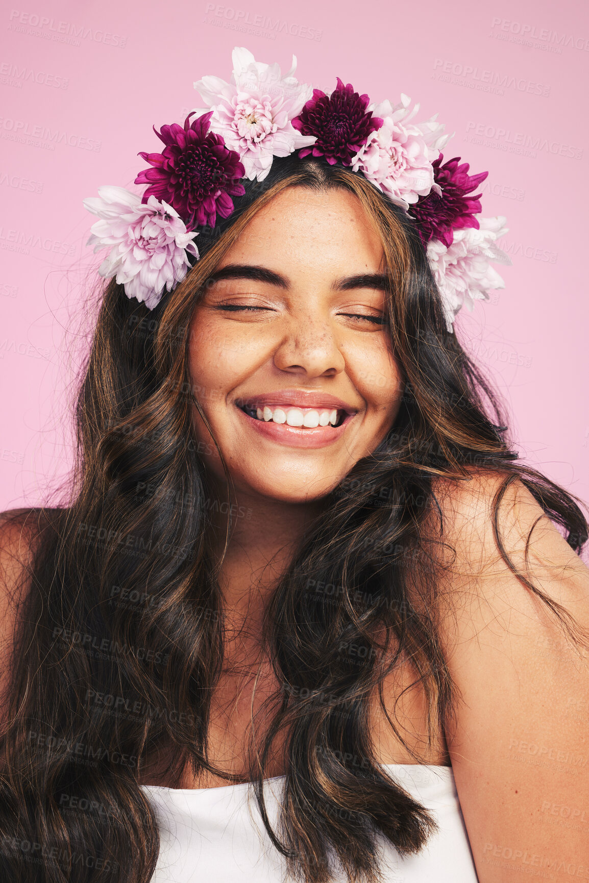 Buy stock photo Woman, flowers and smile with crown on pink background for natural beauty, skincare and self care in studio. Face, happy model and floral hair band for sustainability, eco dermatology and cosmetics 