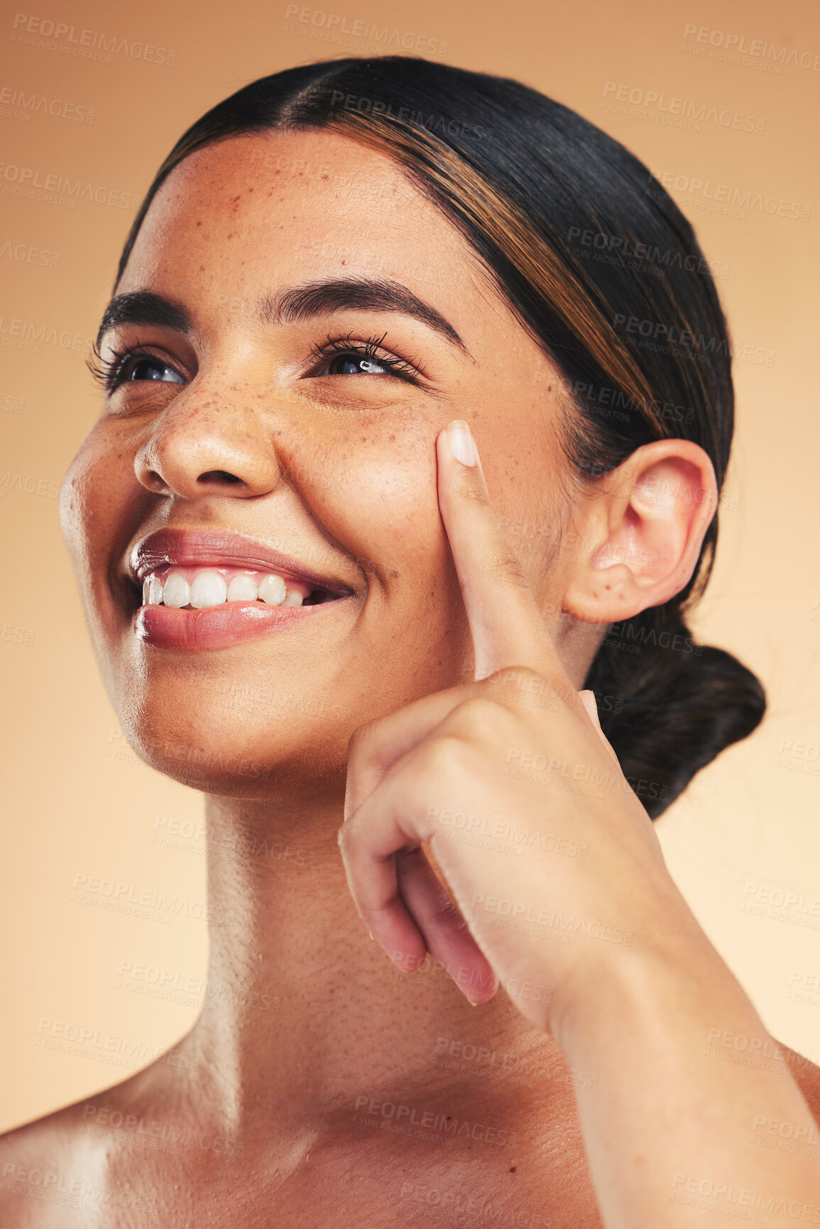 Buy stock photo Skincare, beauty and woman with finger on face for wellness, health and facial care in studio. Dermatology, spa and happy person on brown background in cosmetics, natural glow and satisfaction touch