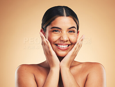 Buy stock photo Skincare, smile and hands on woman face in studio for cosmetic, wellness and dermatology on brown background. Beauty, portrait and lady model happy with glowing skin, results or self love cosmetology