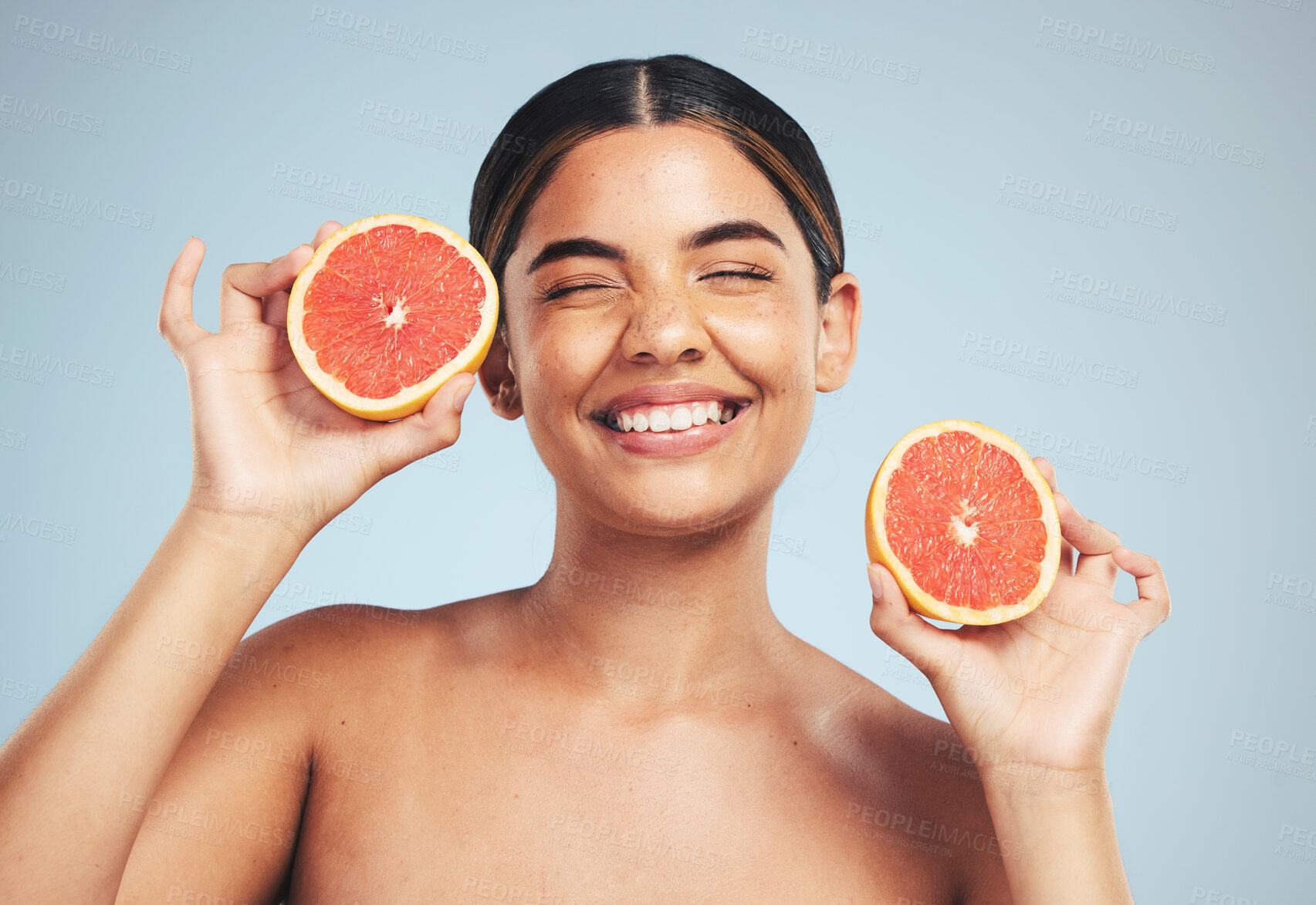 Buy stock photo Happy, woman and grapefruit skincare in studio for natural, cosmetic and wellness on grey background. Face, smile and model with citrus, fruit and organic treatment for anti aging, glow or vitamin c