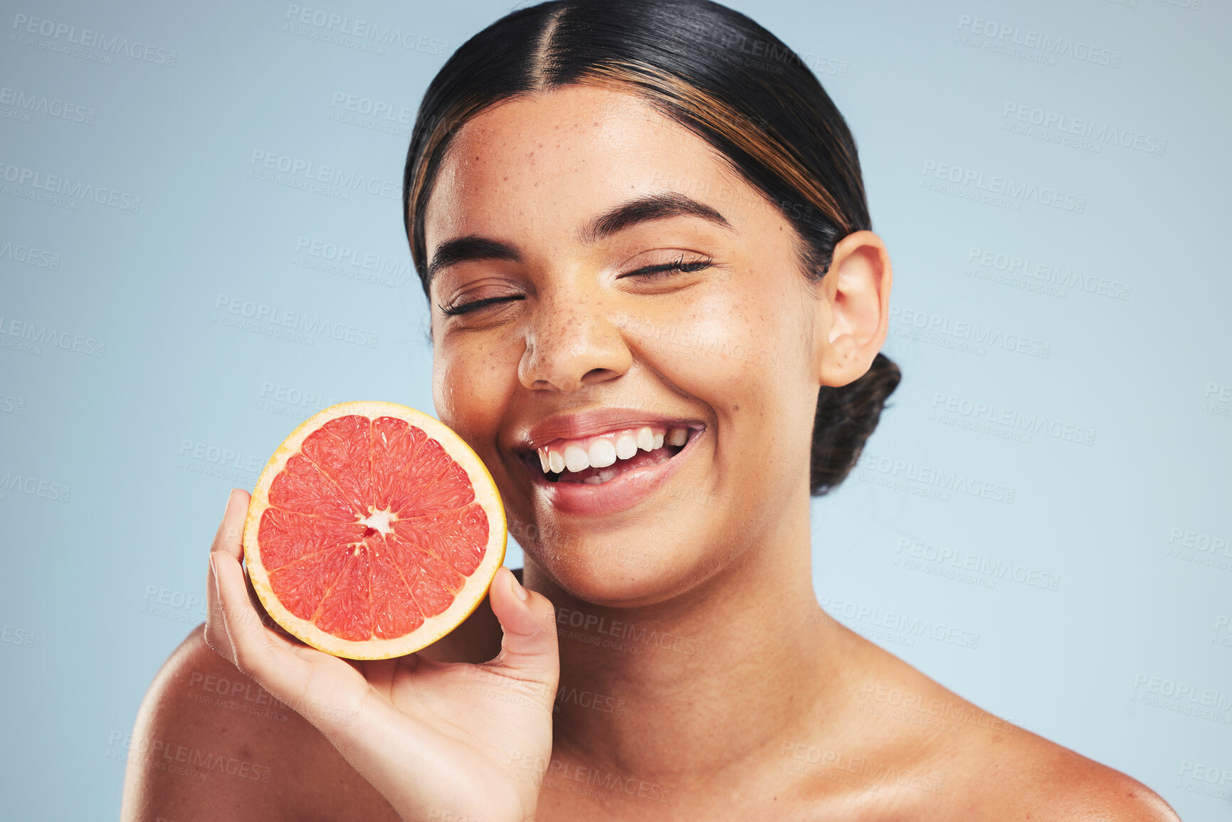 Buy stock photo Happy, skincare and woman in studio with grapefruit for natural skin beauty or wellness on grey background. Smile, fruit and female model with citrus cosmetics for vitamin c, collagen and anti aging 