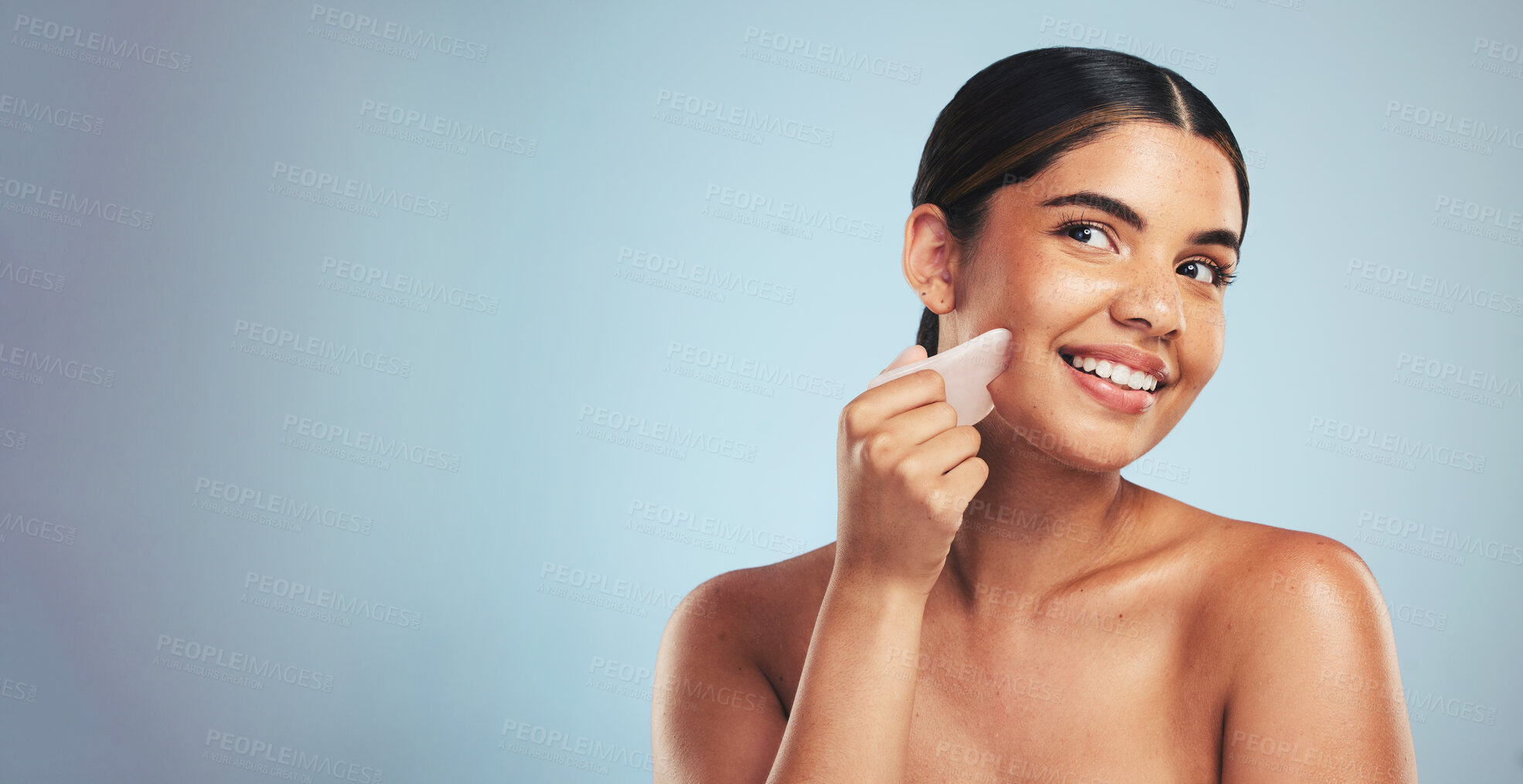 Buy stock photo Gua sha, skincare and woman with face massage in studio for anti aging, wellness and circulation on grey background. Crystal, facelift and beauty model with rose quartz for lymphatic drainage facial