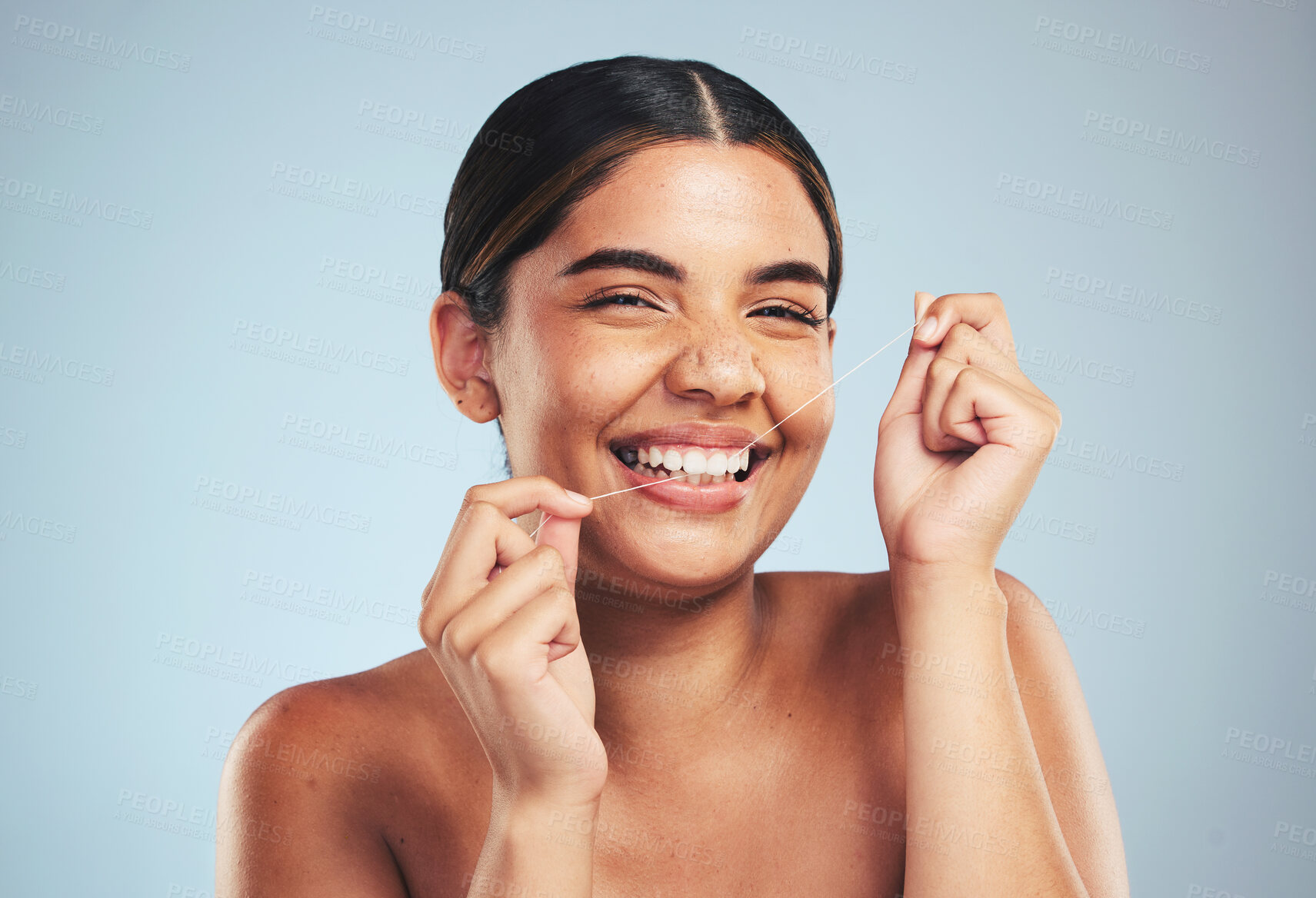 Buy stock photo Woman, portrait and smile to floss teeth in studio for dental hygiene, care and gum gingivitis on blue background. Happy model cleaning mouth with oral thread for fresh breath, healthy habit or tooth