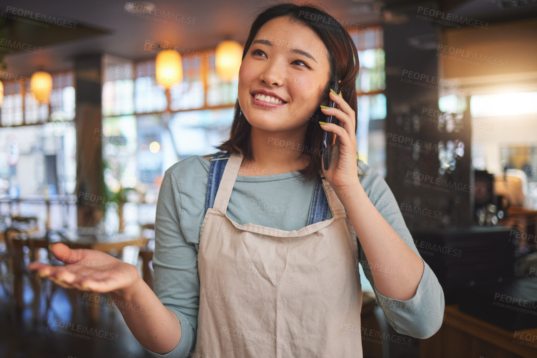 Buy stock photo Restaurant, phone call and Asian woman for online order, delivery and food service in cafeteria. Coffee shop, small business and happy waitress, cafe barista or manager on smartphone in discussion