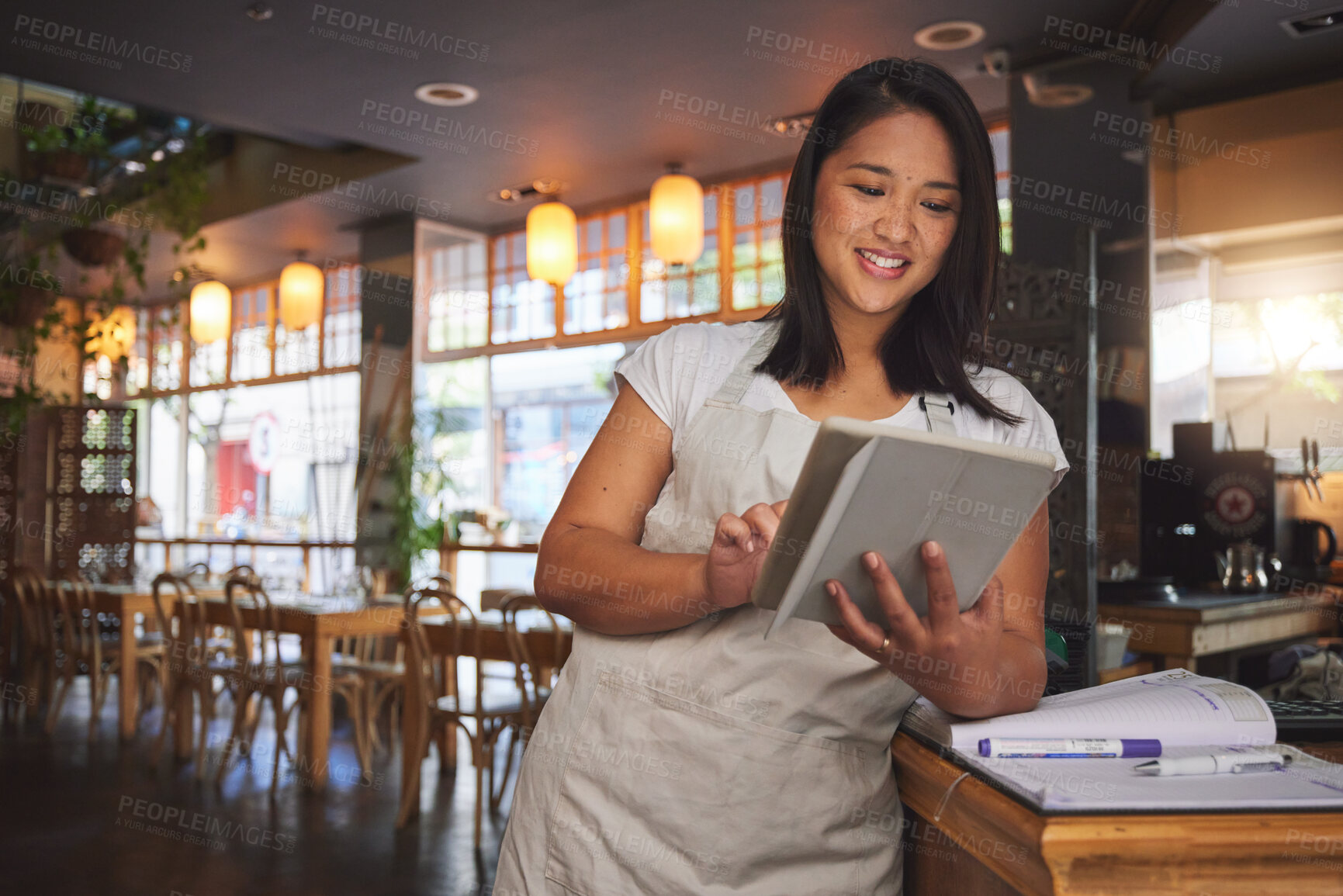 Buy stock photo Restaurant, coffee shop and woman online on tablet for food service, inventory and check menu. Fine dining, small business and happy waitress, barista or manager on digital tech for cafe website