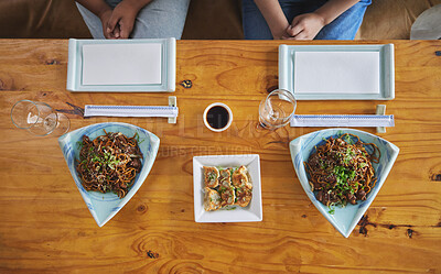 Buy stock photo Chinese food, sushi and noodles on a table in a restaurant from above during a date in an asian eatery. Seafood, cuisine in a bowl and a traditional dish for hunger, nutrition or diet closeup