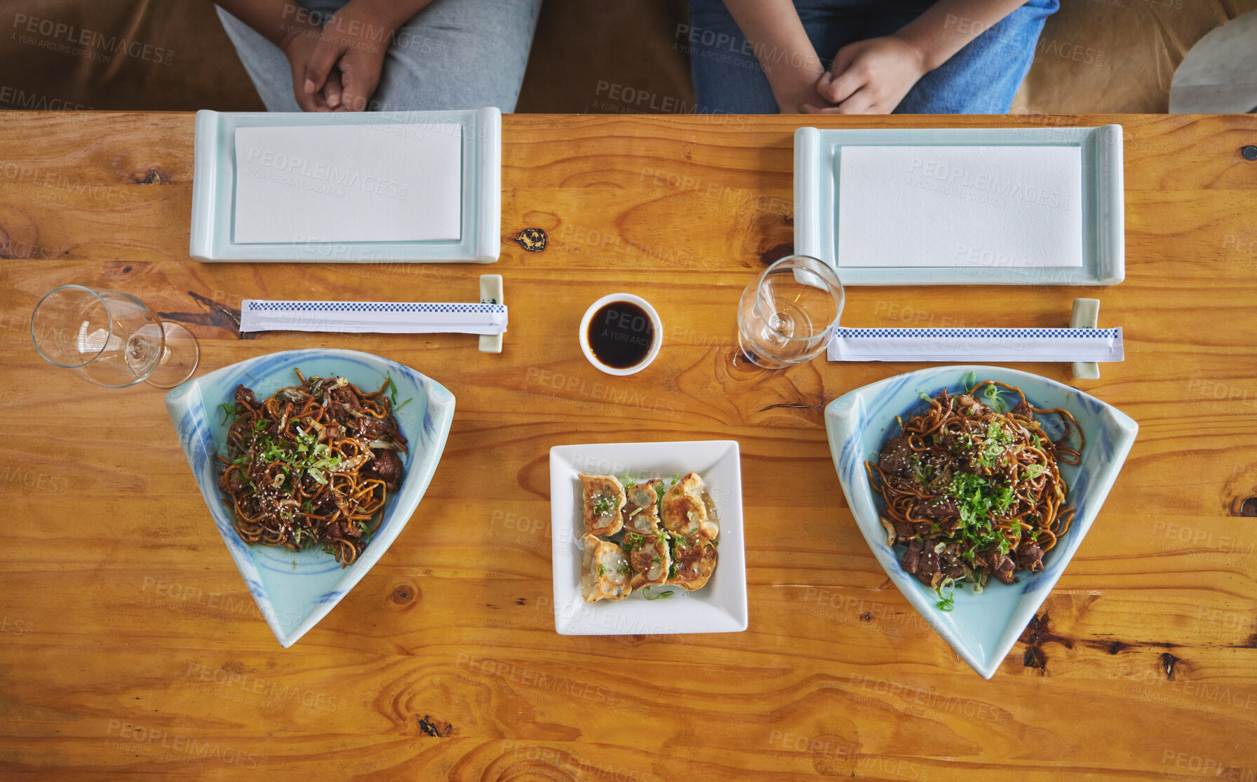 Buy stock photo Chinese food, sushi and noodles on a table in a restaurant from above during a date in an asian eatery. Seafood, cuisine in a bowl and a traditional dish for hunger, nutrition or diet closeup