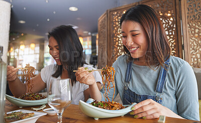 Buy stock photo Restaurant, girl friends and smile with food, noodles and cafe happy from bonding. Asian women, eating and plate together with friendship at a table hungry with chopsticks at Japanese bar gathering