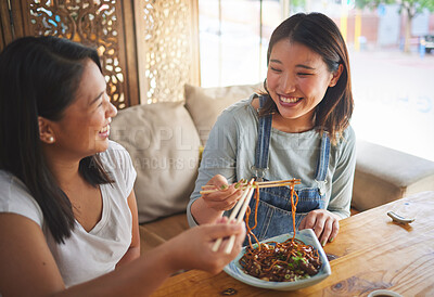 Buy stock photo Chopsticks, restaurant and girl friends eating noodles and Asian cuisine at a cafe. Happy, hungry women and plate of food at a Japanese bar with friendship, smile and bonding from meal at a table